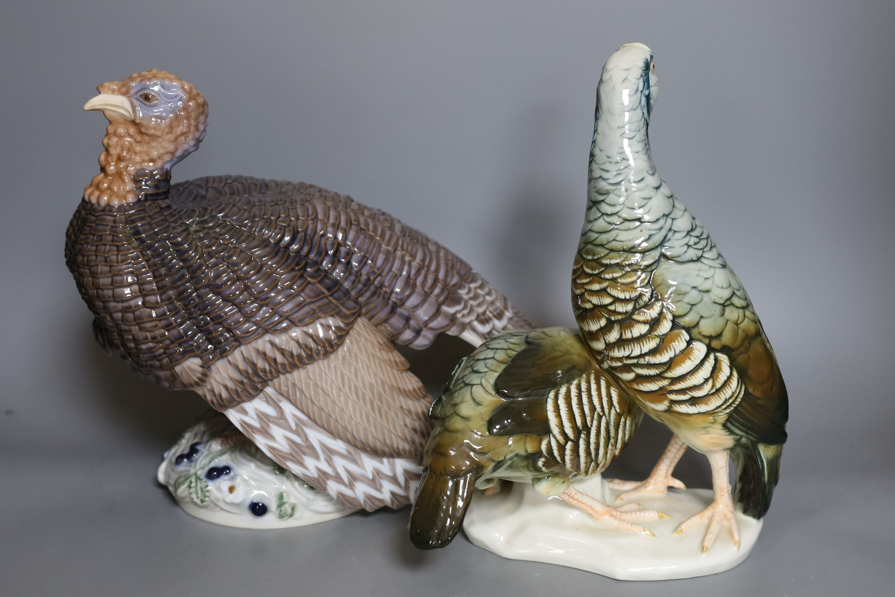 A Rosenthal porcelain model of two guinea fowl, impressed model number 205, a Bing & Grondahl limited edition model of a turkey, no.31 of 750, model 2426 or 2727, a Royal Dux porcelain model a heron and a Karl Ens group